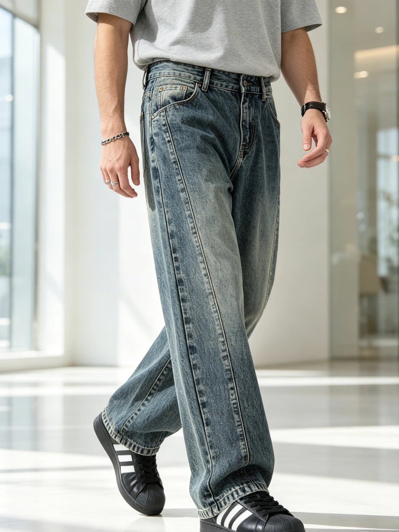 Men's jeans are cut to accommodate various leg shapes, with classic back pocket design and a loose fit.