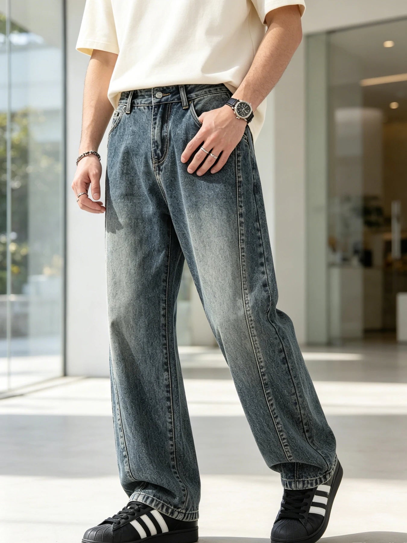 Men's jeans are cut to accommodate various leg shapes, with classic back pocket design and a loose fit.